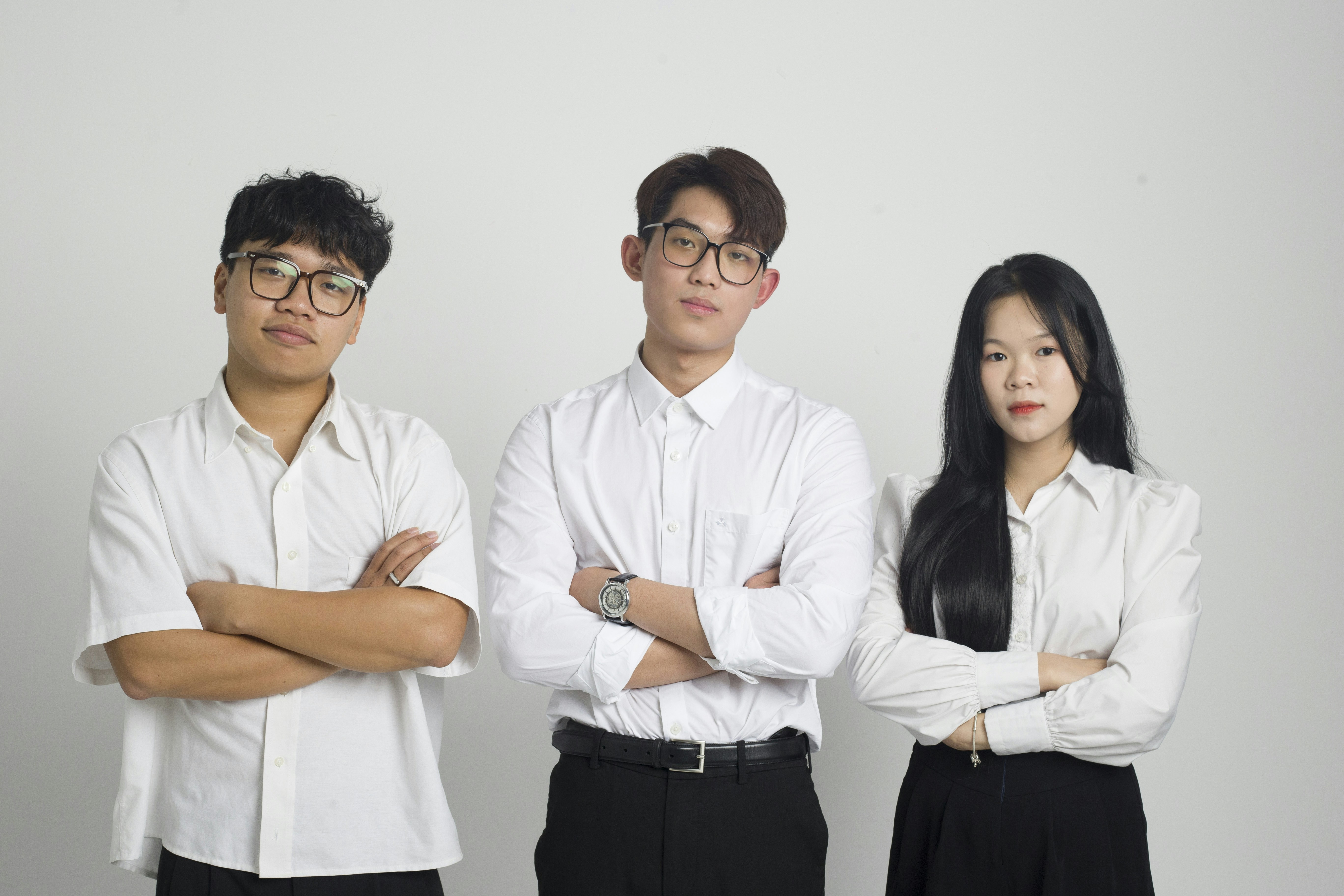 a group of three people standing next to each other
