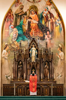 a priest standing at the alter of a church