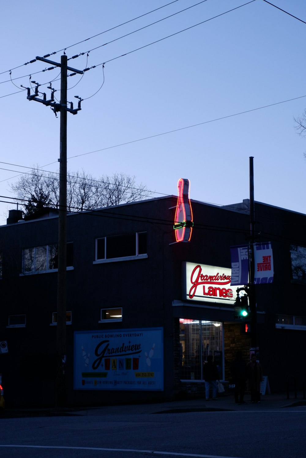 a building that has a neon sign on the side of it