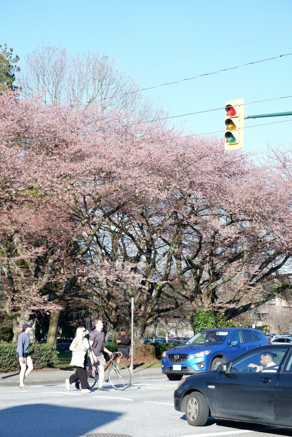 a group of people crossing a street at a traffic light