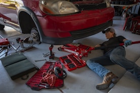a man working on a car in a garage