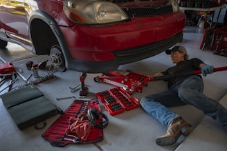 a man working on a car in a garage