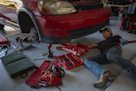 a man working on a car in a garage