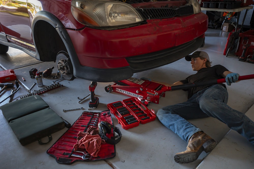 a man working on a car in a garage