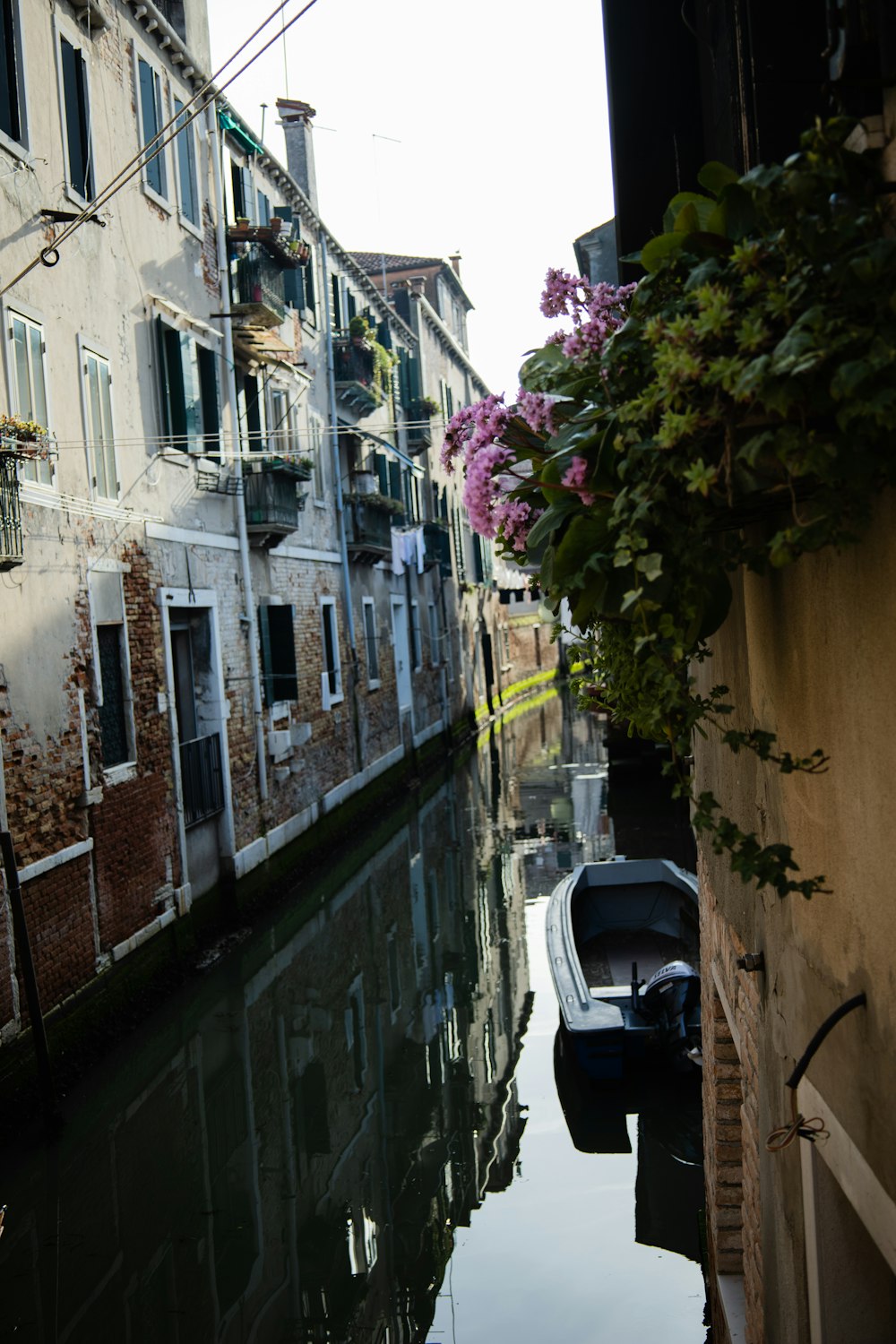 a boat is parked on the side of a canal