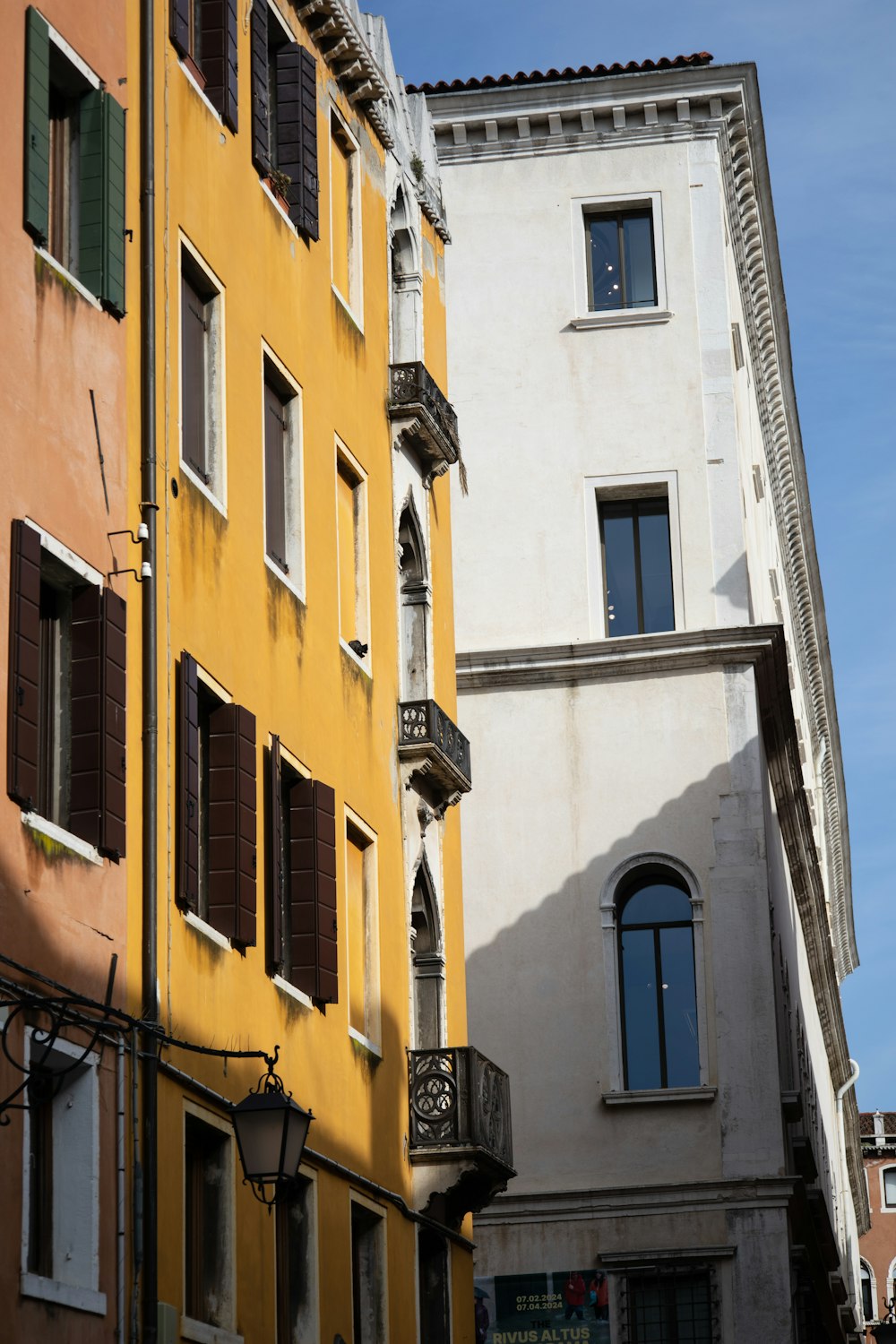 a tall building with lots of windows next to other buildings