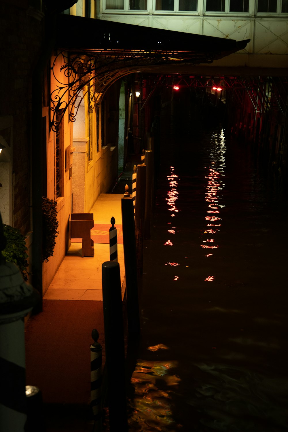 a dark street at night with a bench in the middle of the street