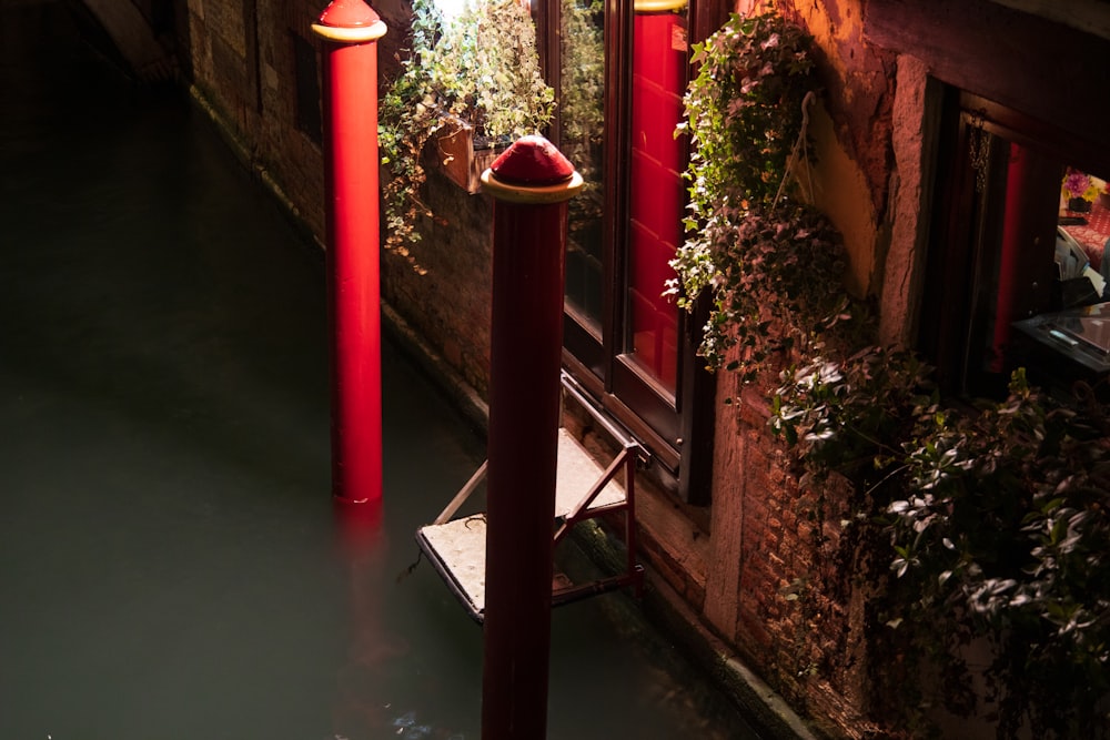 a couple of red poles sitting next to a building