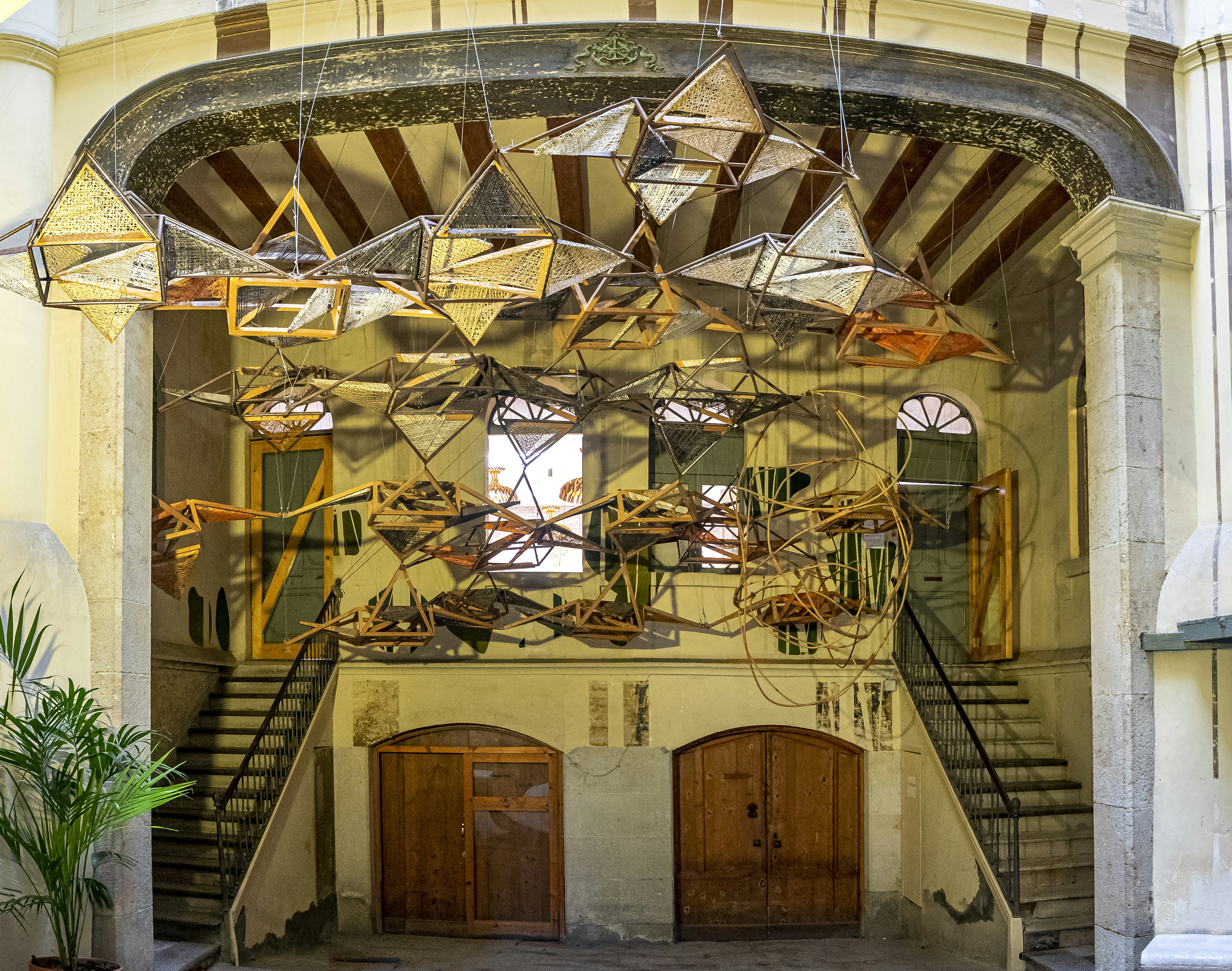 A building with a bunch of hanging objects in the middle of it photo ...