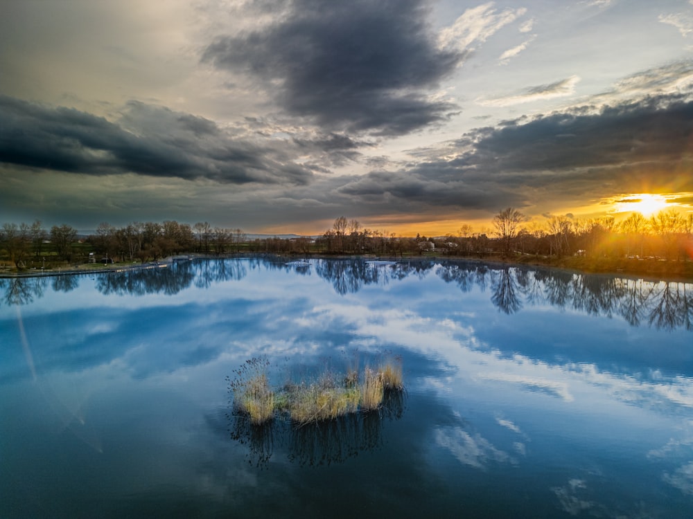 a large body of water under a cloudy sky