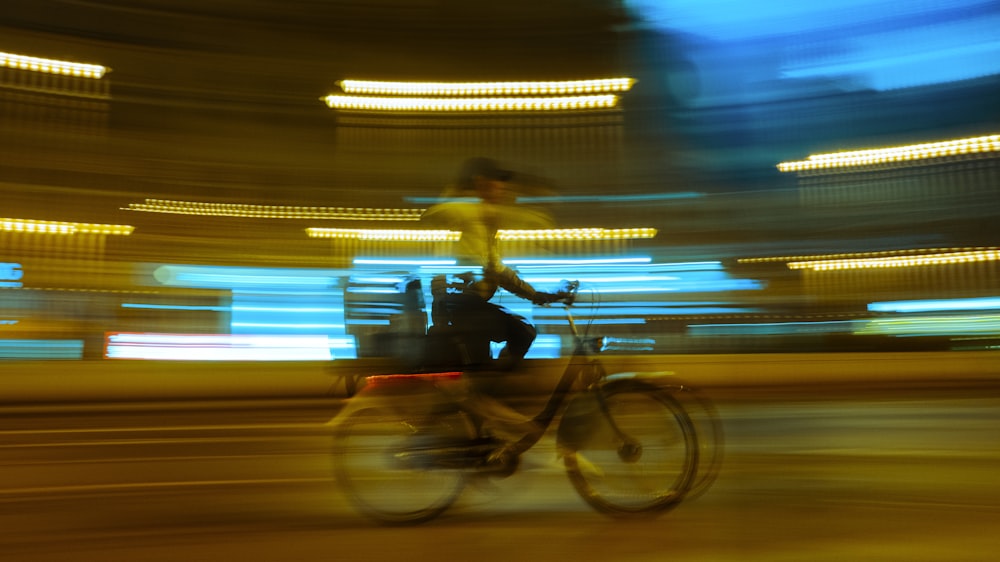 a blurry photo of a person riding a bike