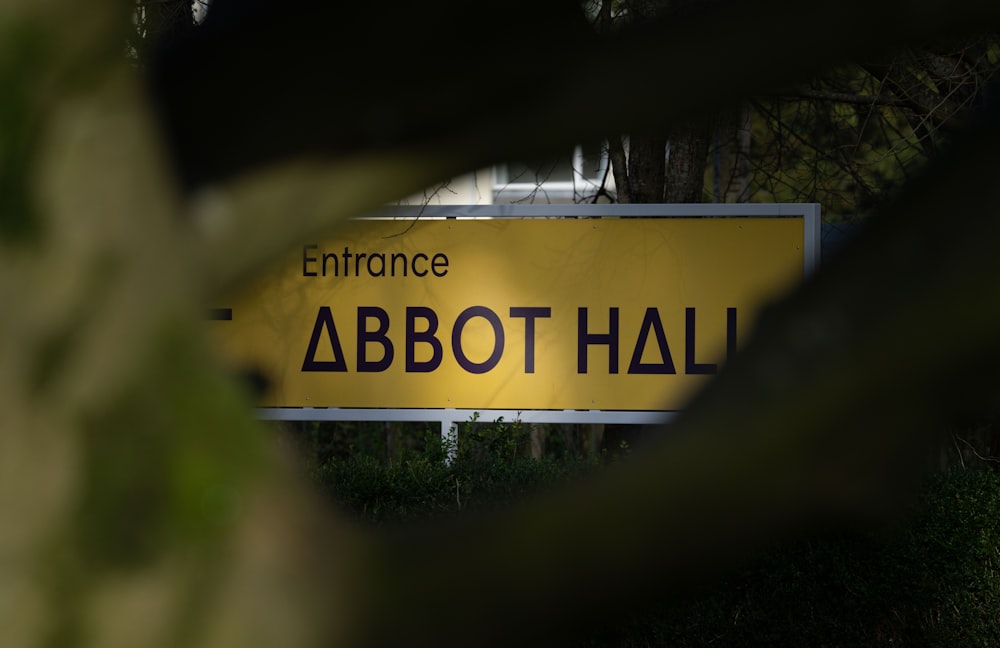 a yellow sign that is on the side of a road