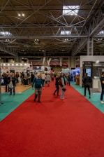 a group of people standing around a red carpet
