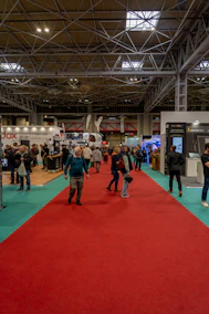 a group of people standing around a red carpet