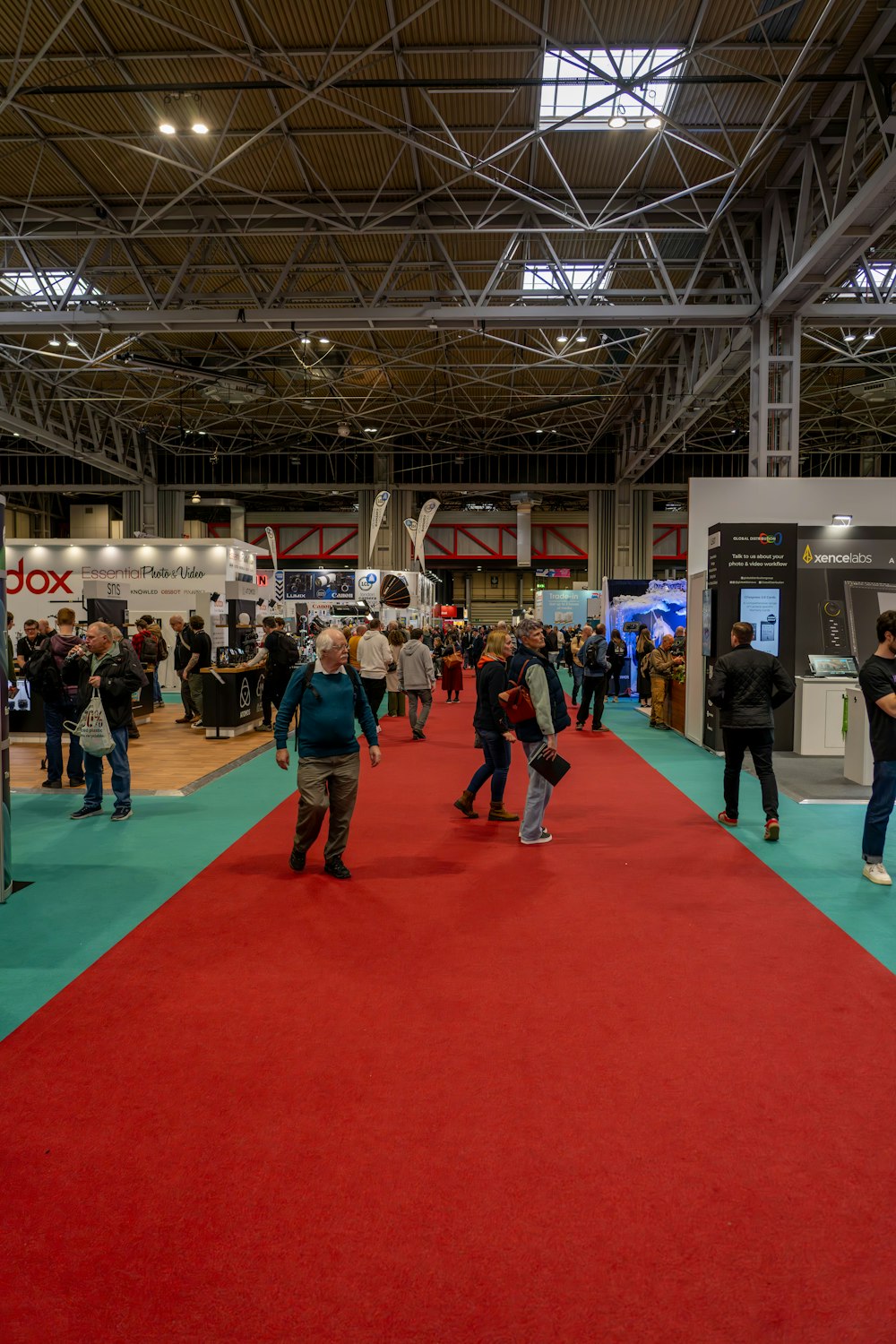 a group of people standing around a red carpet