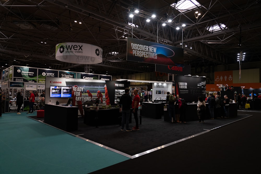 a group of people standing around a trade show