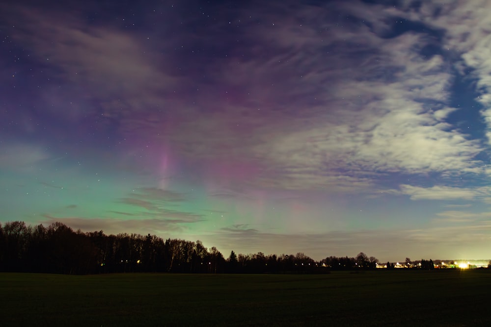 a green and purple aurora bore in the sky