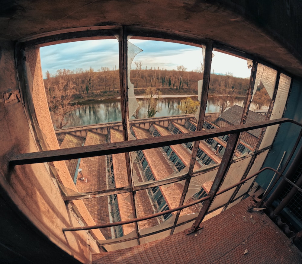 a fish eye view of a building with a lake in the background