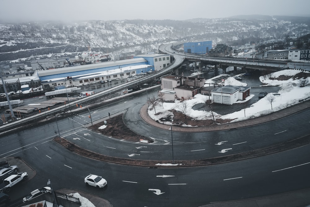 an aerial view of a city street with snow on the ground