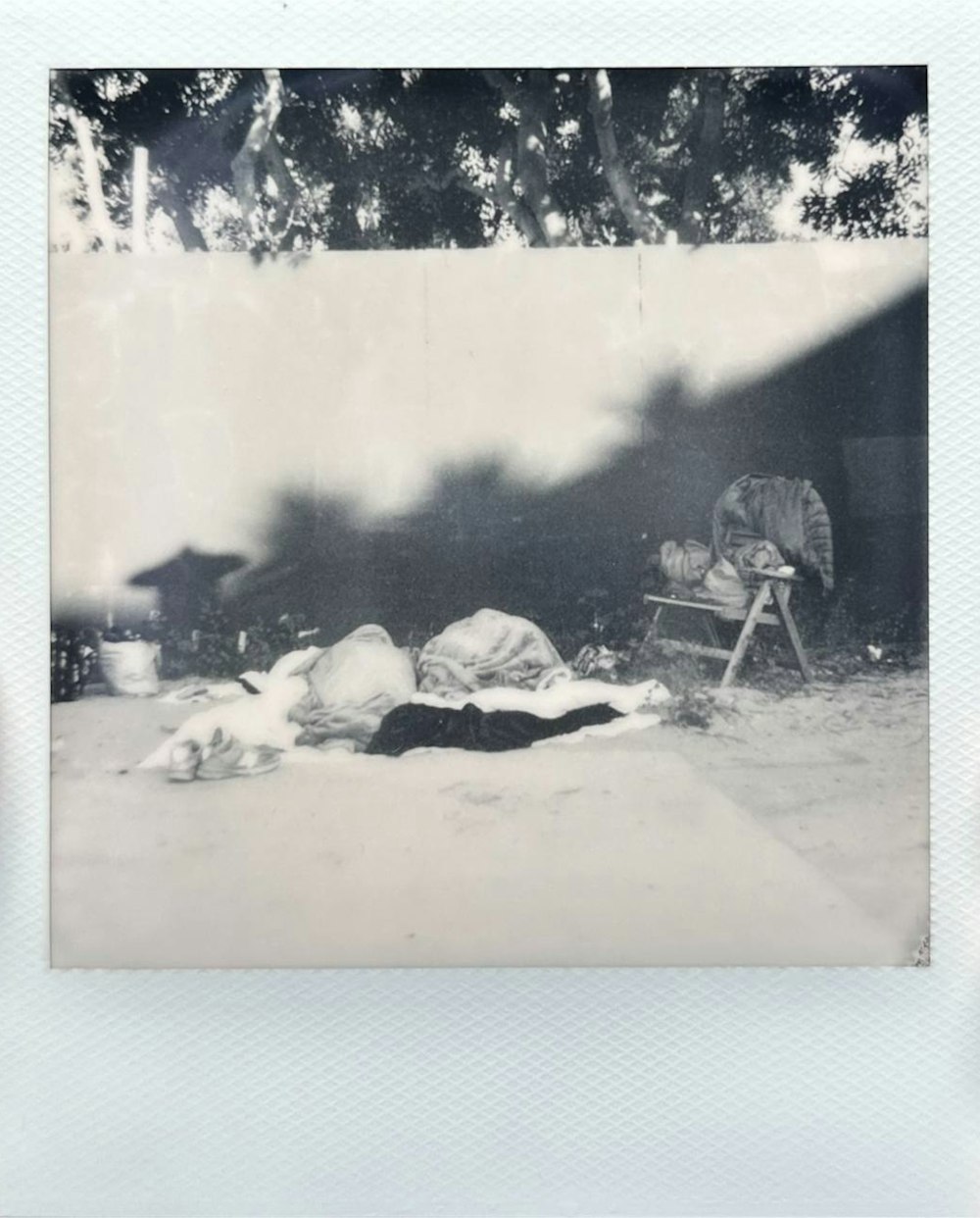 a black and white photo of a person laying on the ground