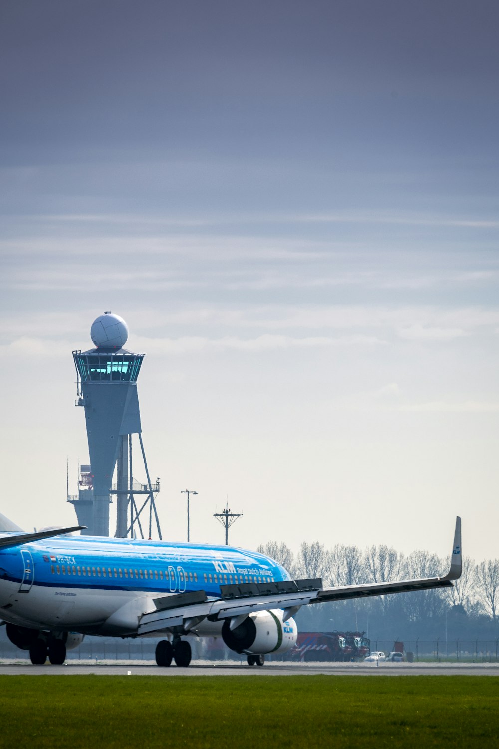 a blue and white airplane is on the runway