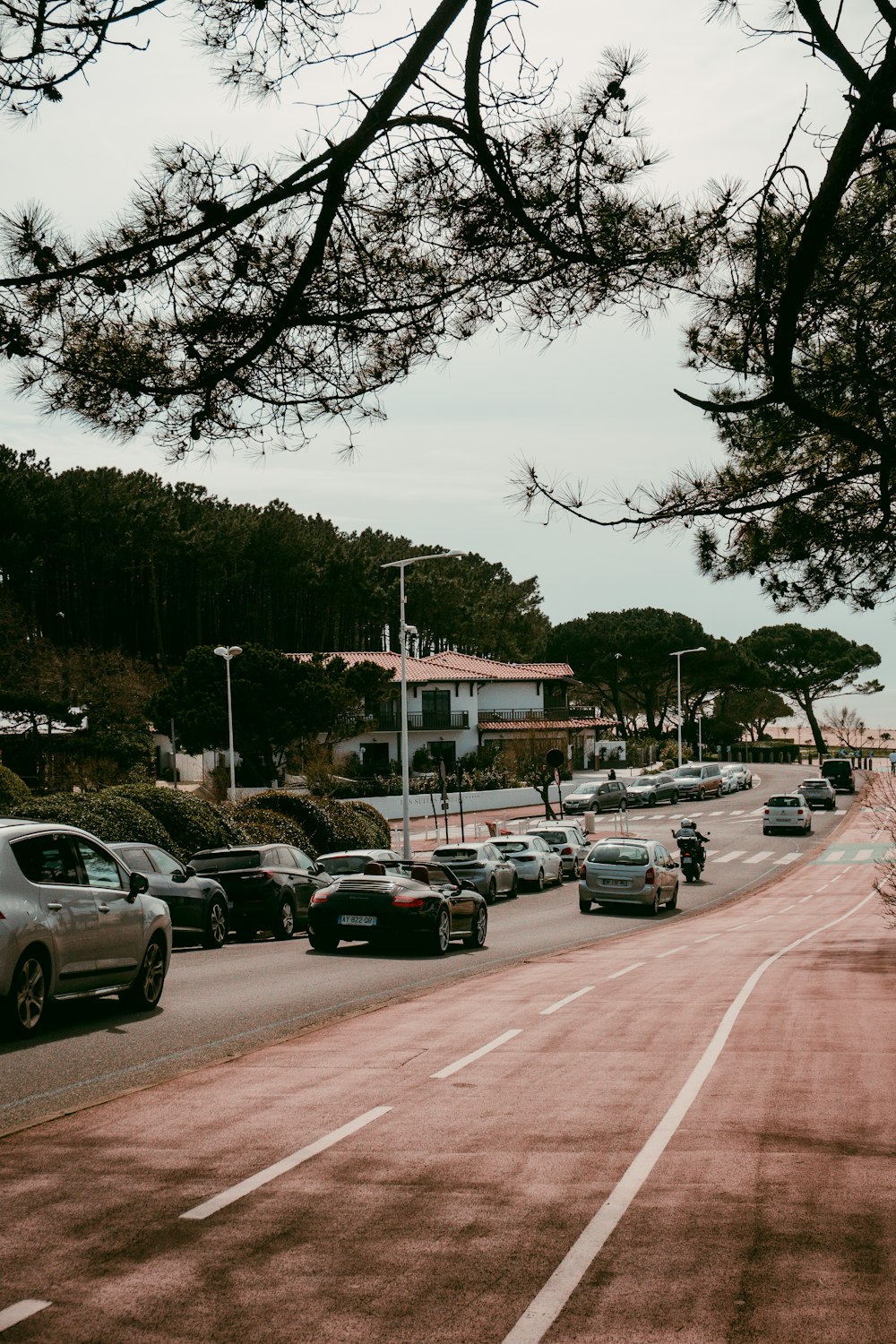 a street filled with lots of traffic next to trees