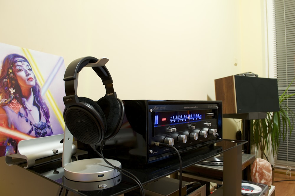 a stereo and headphones on a table in a room