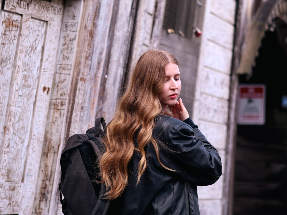 a woman with long hair is talking on her cell phone