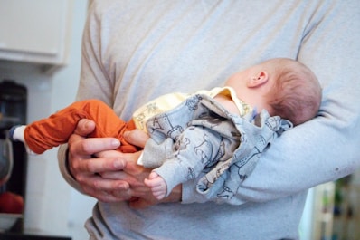 a man holding a baby in his arms