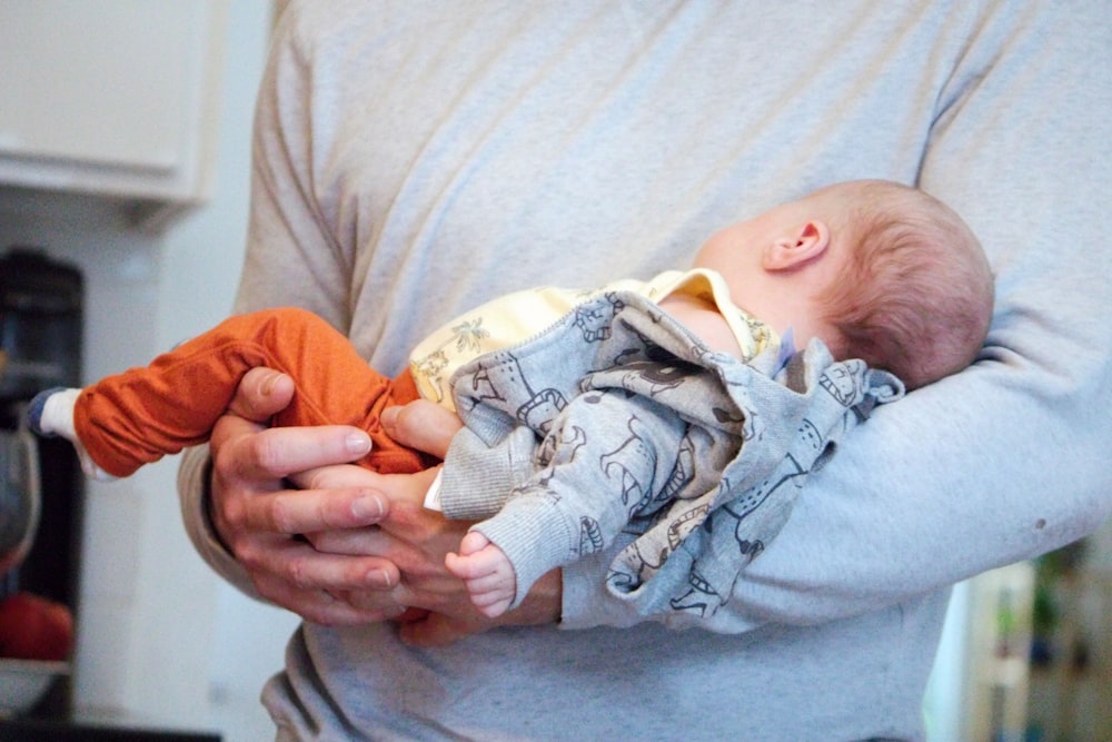 a man holding a baby in his arms