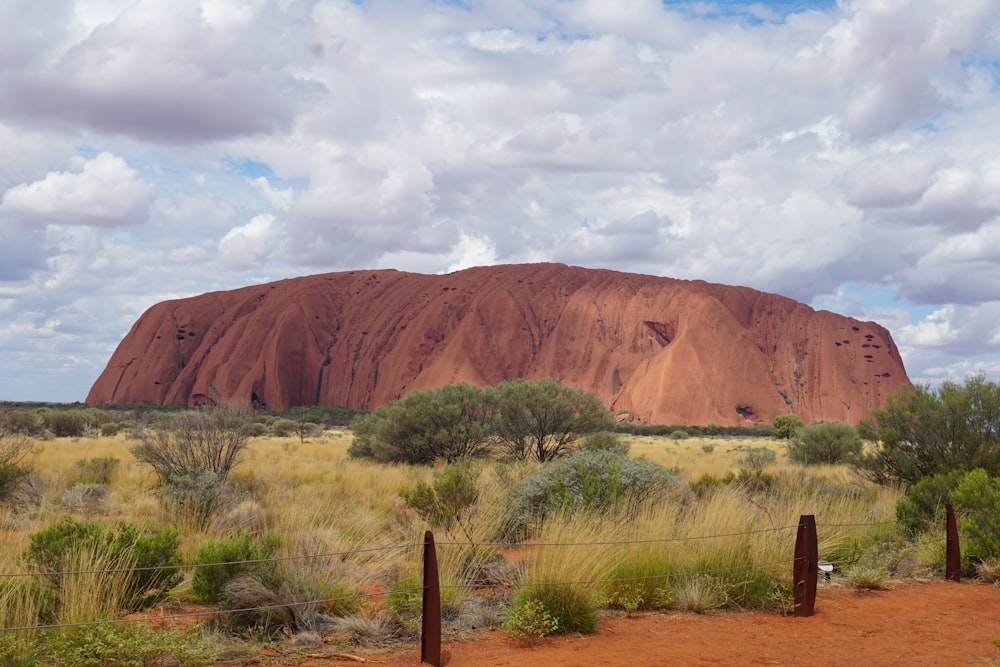 a large rock in the middle of a desert