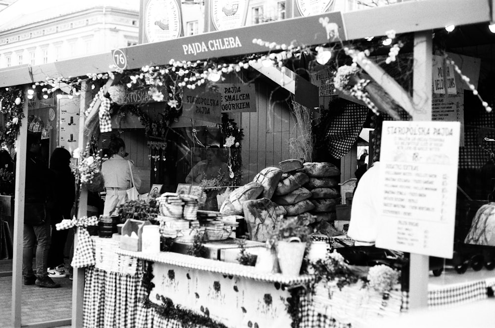 a black and white photo of a food stand