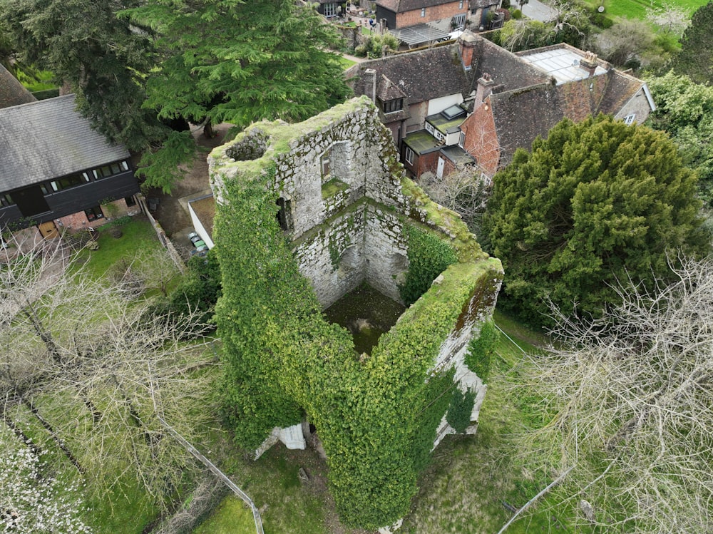 an aerial view of an old building with vines growing on it