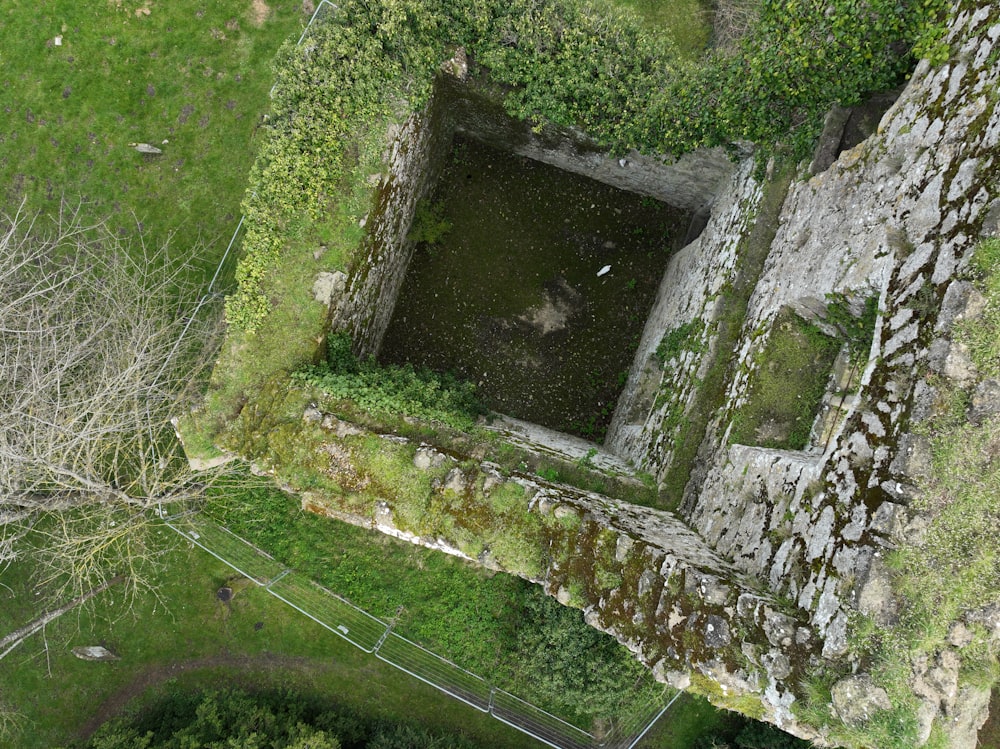 an aerial view of a building with a pool in the middle of it