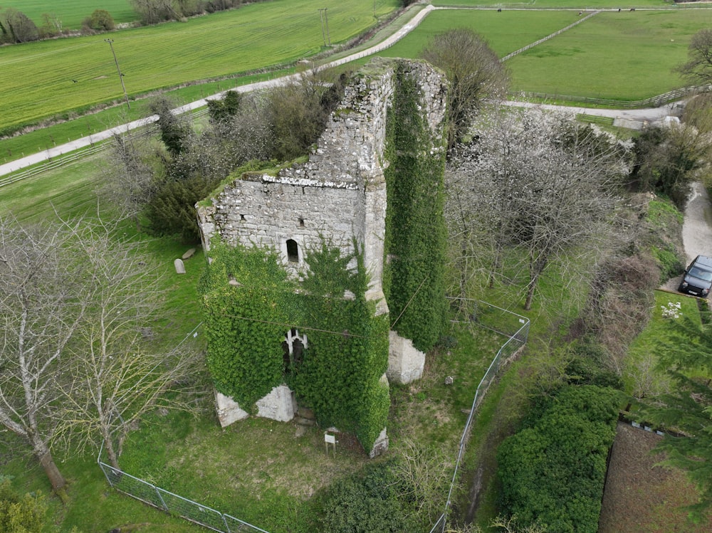 an aerial view of a stone building surrounded by trees