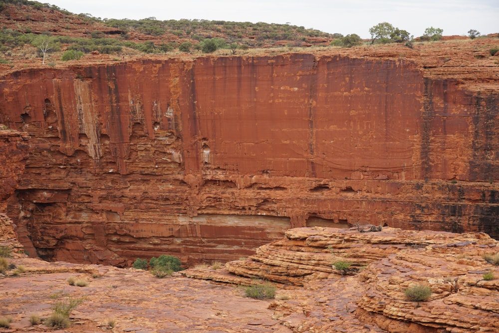 a rocky cliff with a hole in the middle of it