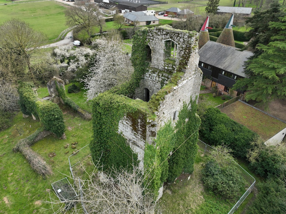 an aerial view of an old building with ivy growing on it