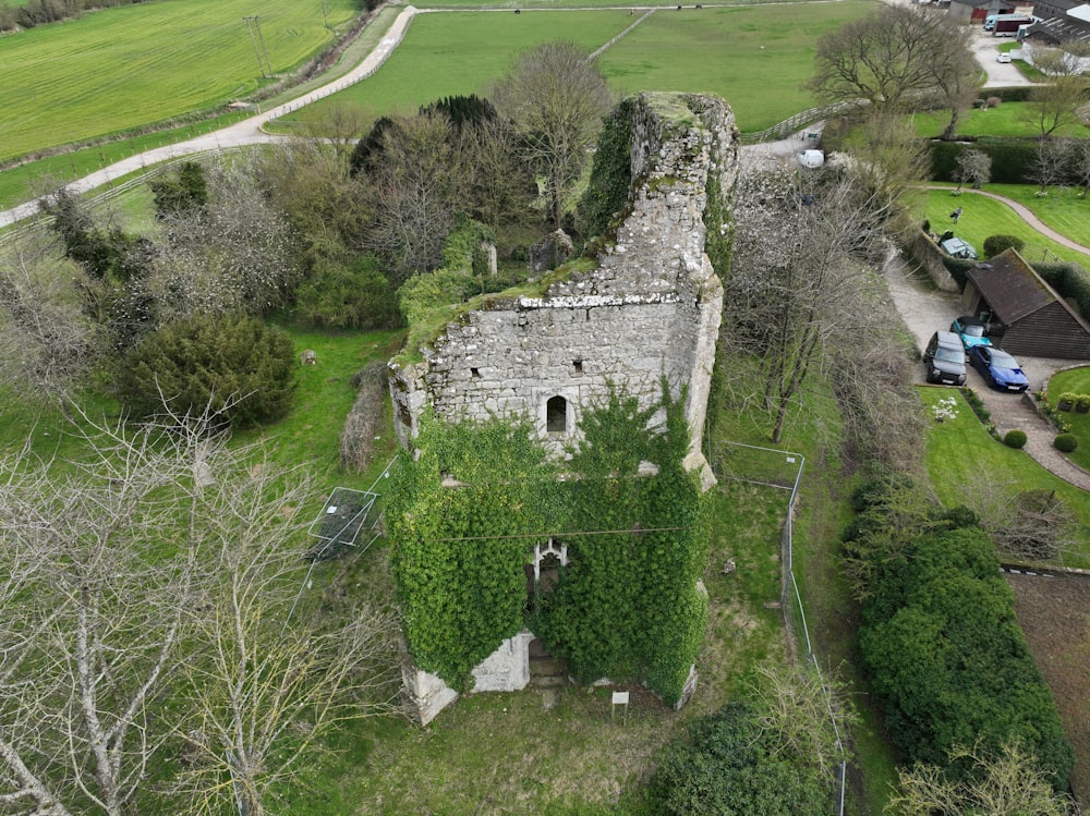 an aerial view of an old building surrounded by trees
