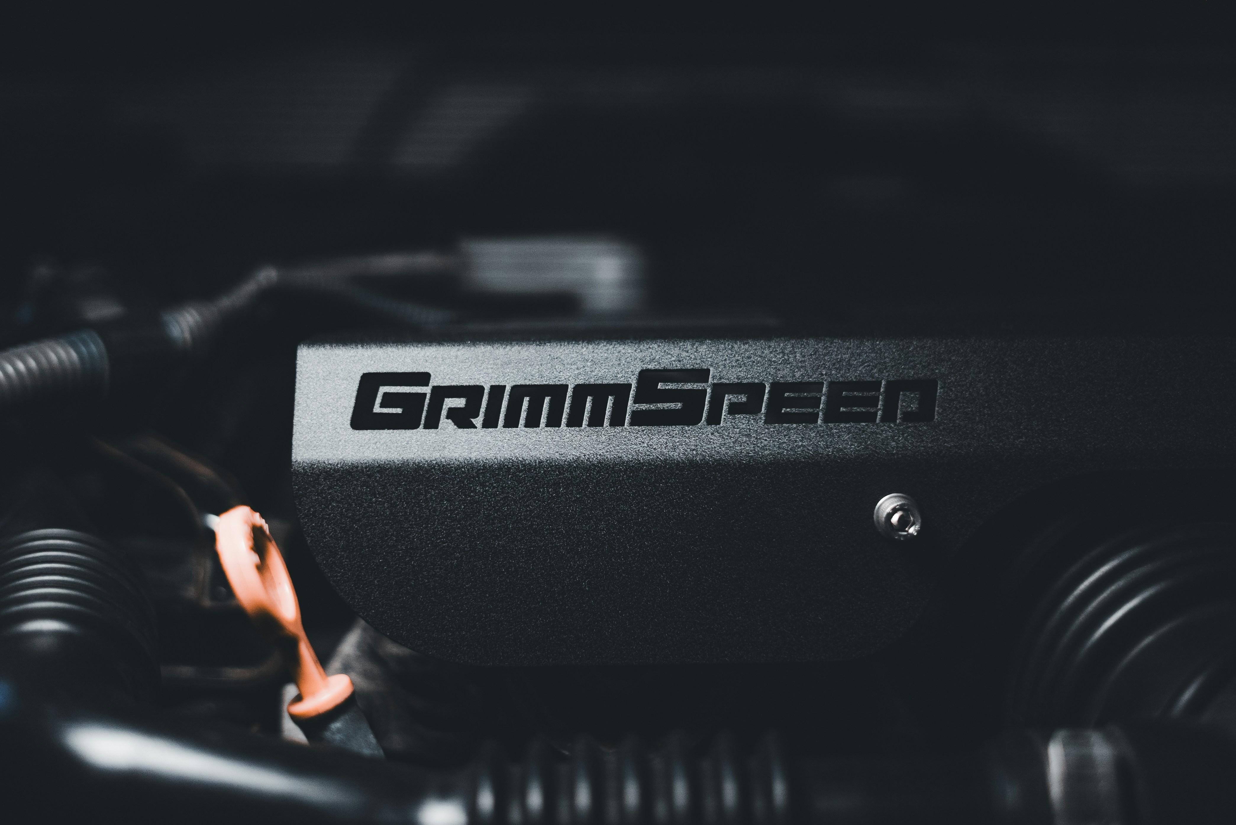 A close-up of a car engine with the wordgrammscreen on it