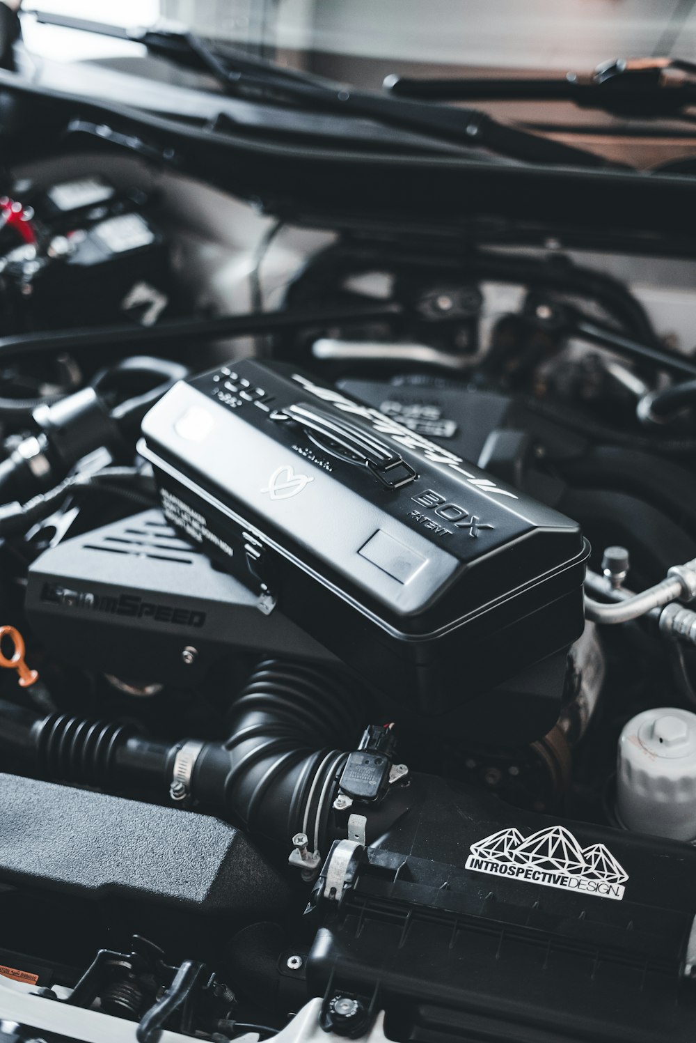 a close up of a car engine with its hood open