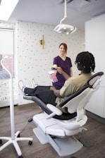 a woman sitting in a chair with a tablet