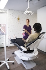 a woman sitting in a chair with a tablet