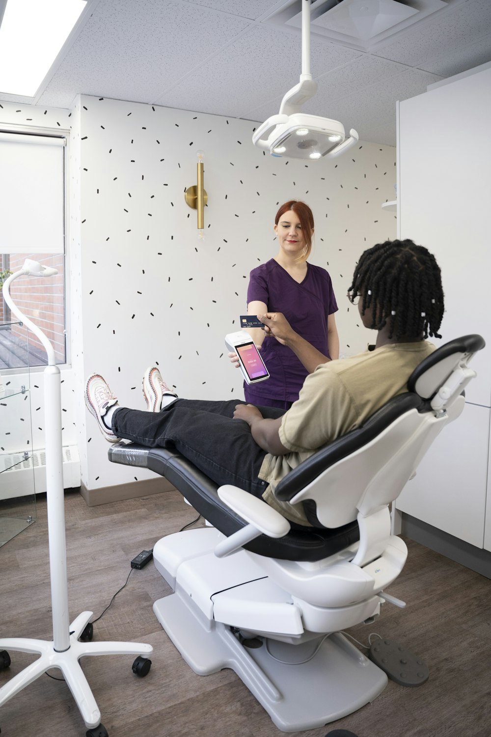 a woman sitting in a chair with a tablet