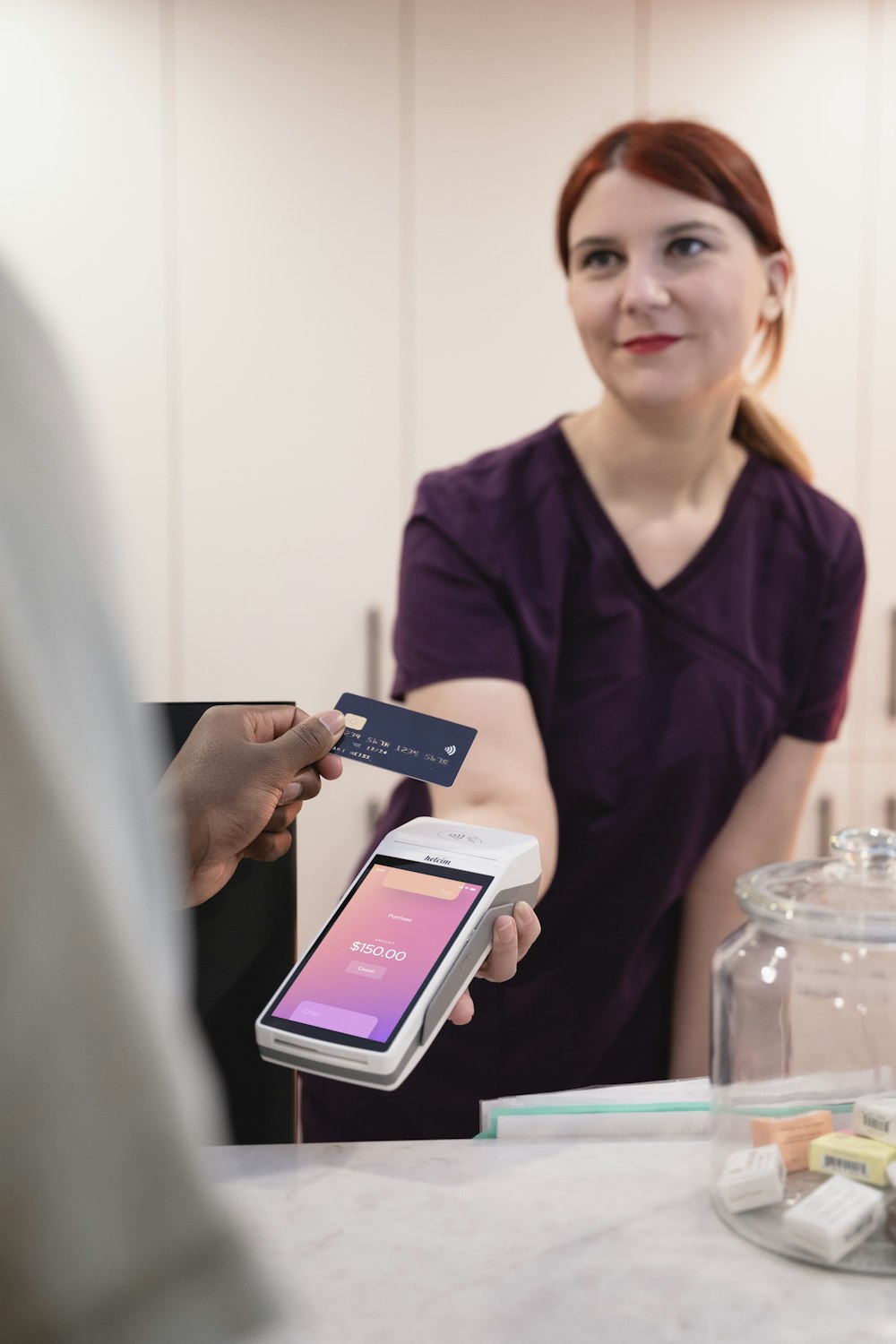 a woman holding a credit card and a cell phone