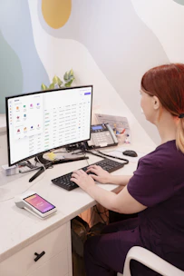 a woman sitting at a desk using a computer