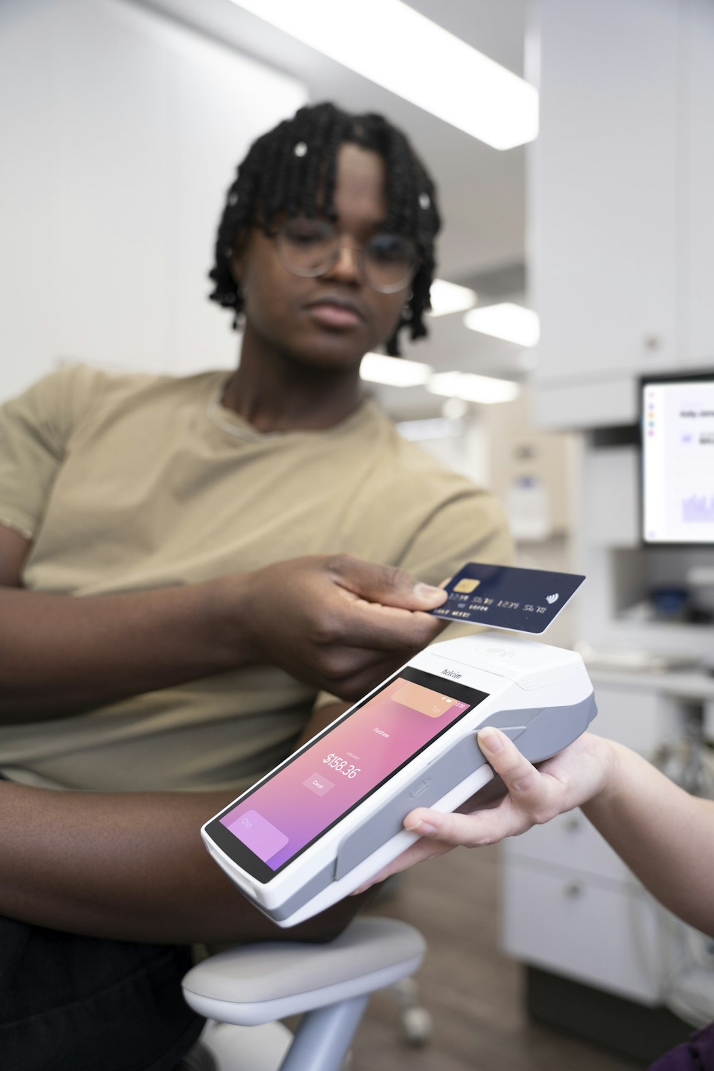 a person holding a credit card and a cell phone