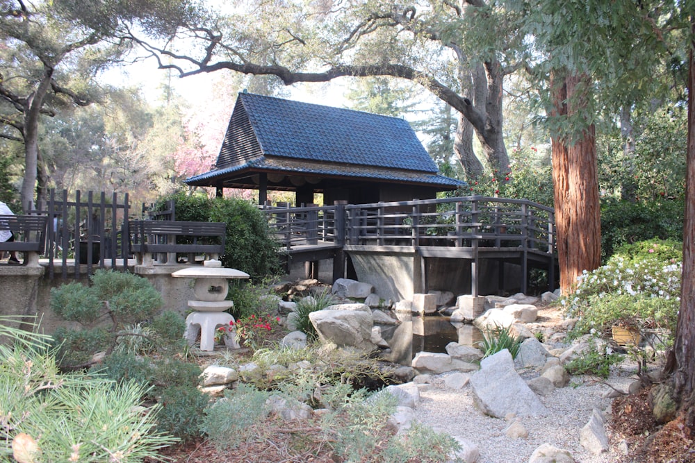 a japanese garden with rocks and a bridge