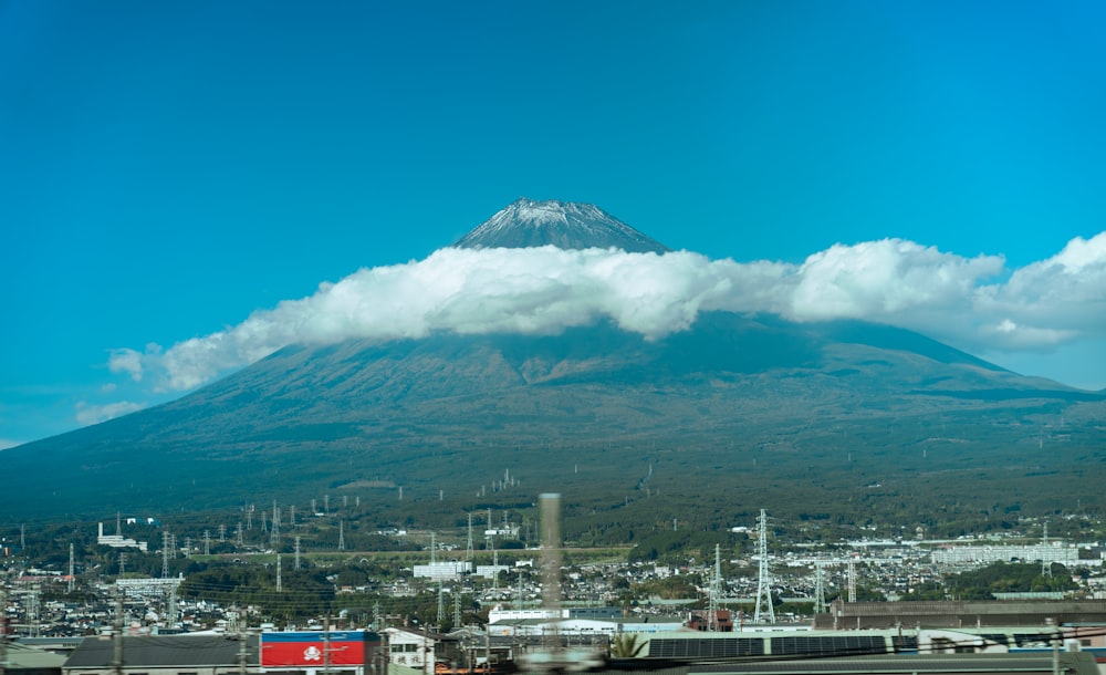 a very tall mountain with a cloud in the sky