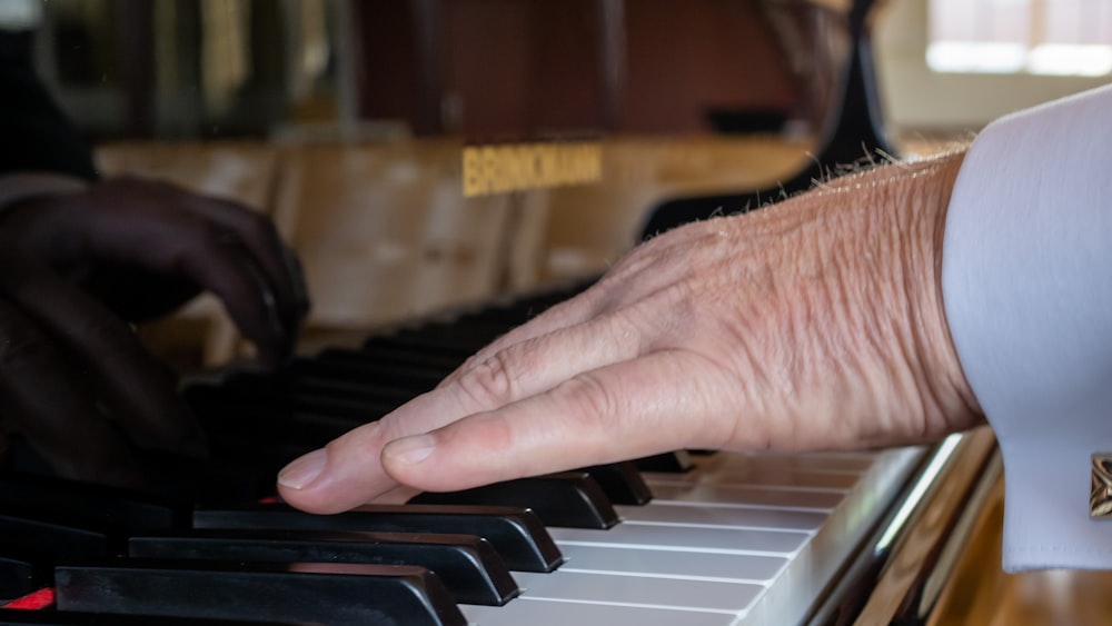 a close up of a person playing a piano