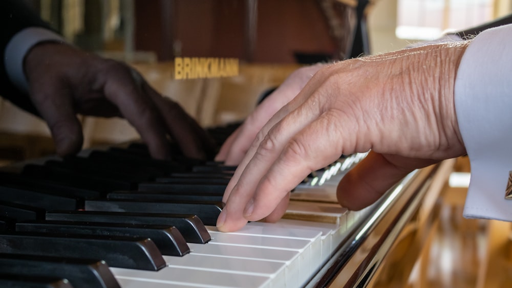 a close up of a person playing a piano